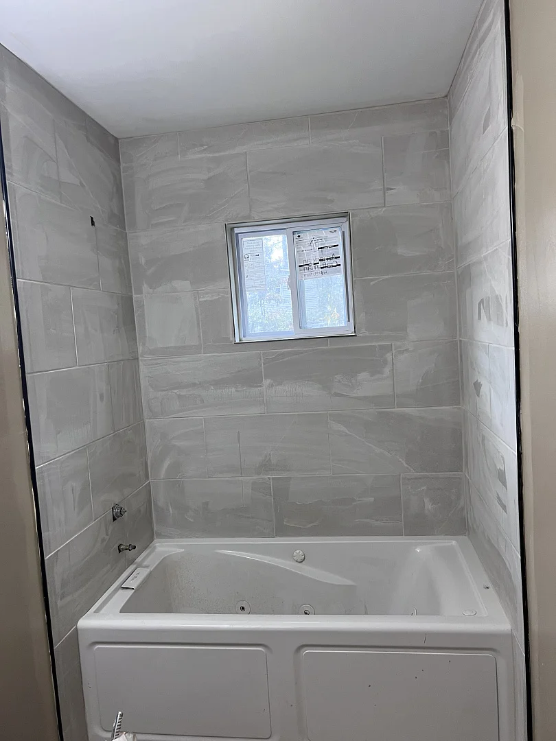 Newly installed floor tile with clean grout lines in a modern home interior.